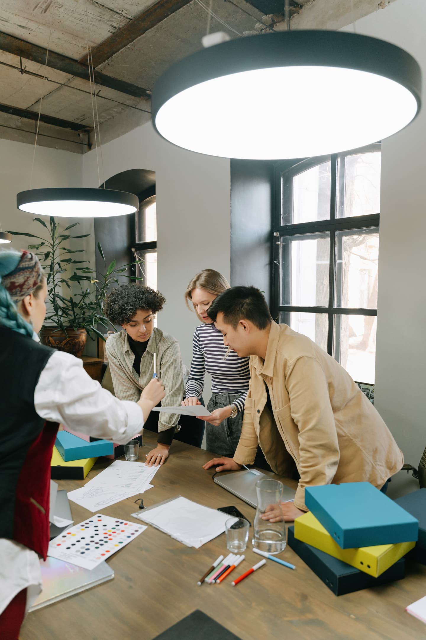 A multidisciplinary team reviewing product designs around a table